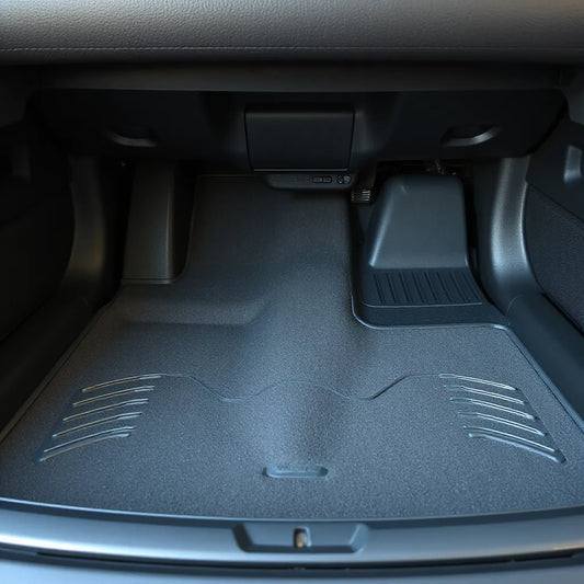 Clean, well-fitted car floor mats with textured anti-slip surface in a modern car interior