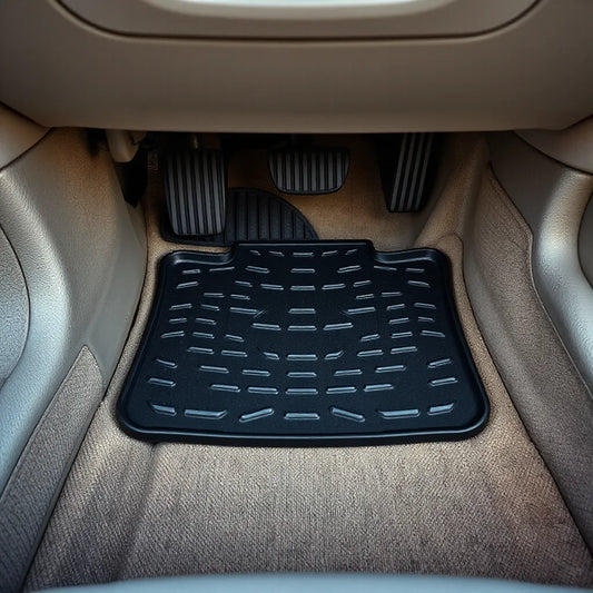 Driver footwell showing a textured driver footpad with pedals in the background