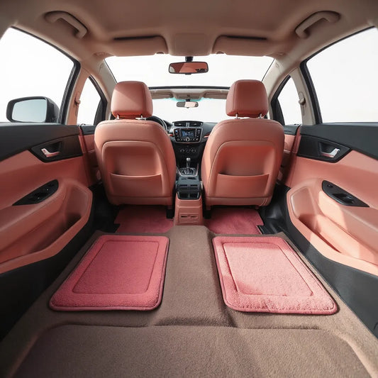 Pink car mats neatly installed on the front passenger and driver floors with clean interior flooring visible